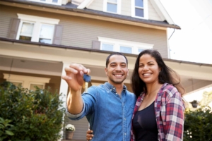 Happy couple holding up new house keys